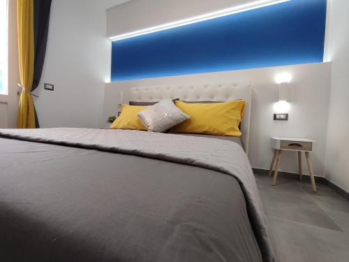 a bedroom with a large bed with yellow pillows at Il Sogno di Giò in Alghero