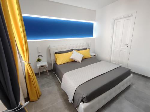 a bedroom with a large bed with yellow pillows at Il Sogno di Giò in Alghero