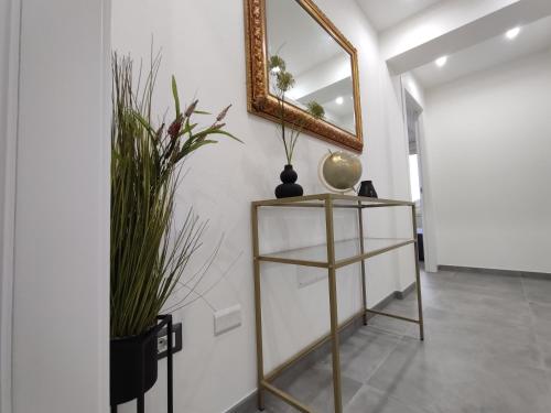 a room with a mirror and a shelf with plants at Il Sogno di Giò in Alghero