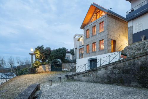 a building with a staircase leading up to it at Casa da Corina in Amarante
