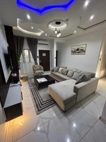 a living room with a couch and a table at Sparkles Apartments in Abuja