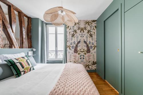um quarto com uma cama com paredes verdes e uma janela em Brand New Luxury Flat in Parc Monceau - Batignolles em Paris