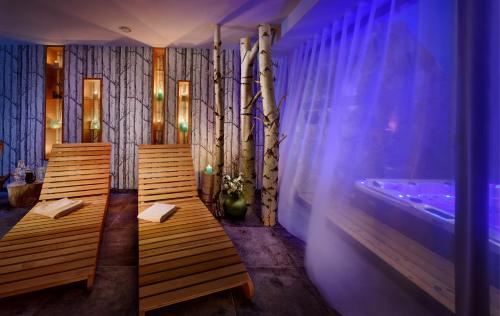 two wooden benches in a room with a bath tub at ChaletSKI Jasná, SKI-IN & SKI-OUT in Demanovska Dolina