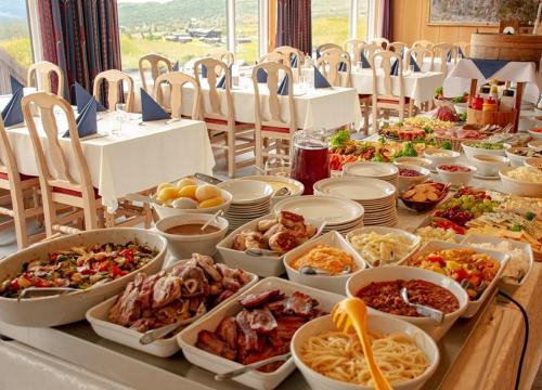 a buffet with many different dishes of food on a table at Rondane Haukliseter Fjellhotell in Høvringen