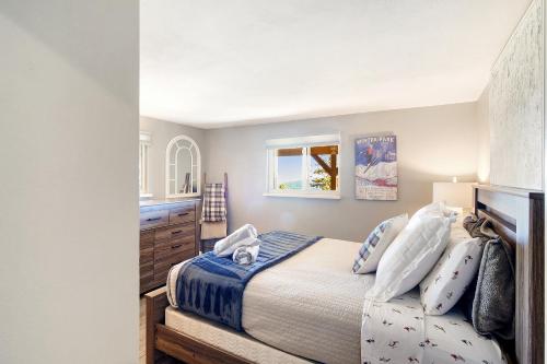 a bedroom with a bed and a window at The Tree House in Evergreen