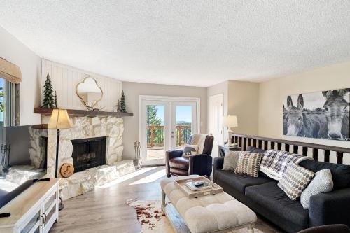 a living room with a couch and a fireplace at The Tree House in Evergreen