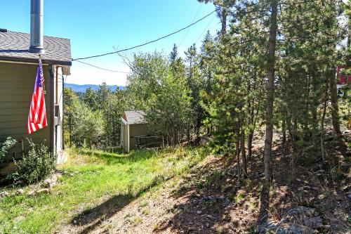 an empty yard next to a house with a flag at The Tree House in Evergreen
