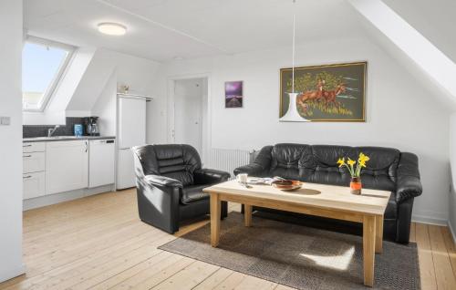 a living room with a couch and a coffee table at 1 Bedroom Nice Apartment In Thyborøn in Thyborøn