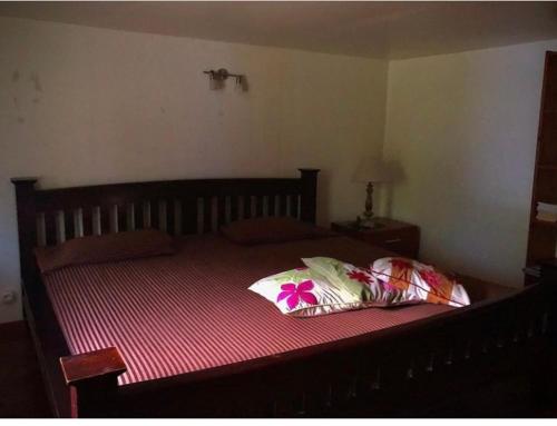 a bedroom with a large bed with a red blanket at Hiti Lodge in Fare