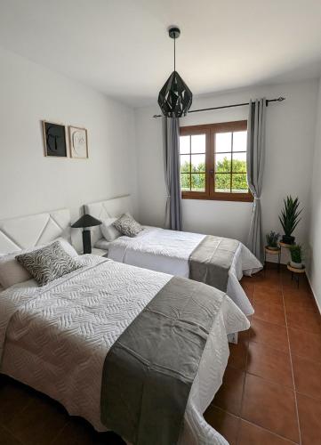 a bedroom with two beds and a window at La Palma Nature in Barlovento