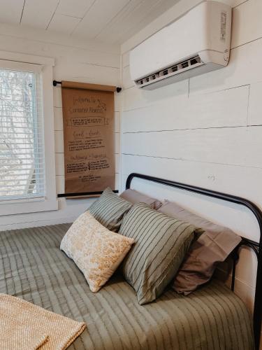 a bed with two pillows on it in a room at Shipping Container Home near Fall Creek Falls State Park in Dunlap
