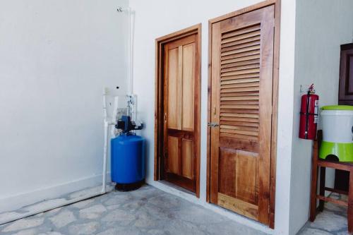 a room with a wooden door and a fire hydrant at El Remate Panoramic View House 3 Levels Peten in Jobompiche