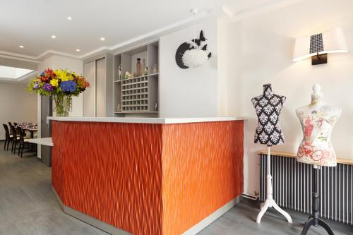 a store with a colorful counter with a mannequins on display at Hotel Miramar in Paris
