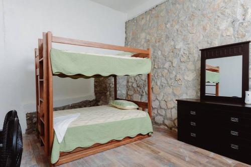 a bedroom with two bunk beds and a mirror at El Remate Panoramic View House 3 Levels Peten in Jobompiche