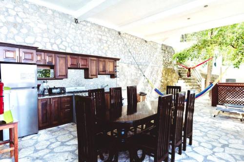 a kitchen with a table and chairs and a refrigerator at El Remate Panoramic View House 3 Levels Peten in Jobompiche