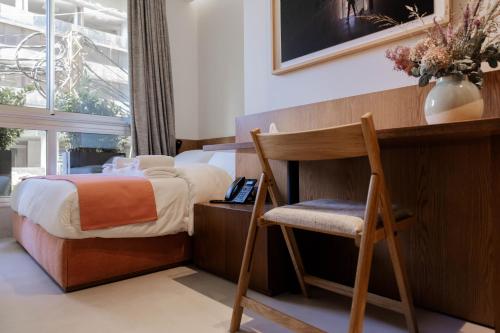 a bedroom with a bed and a chair and a desk at Zita Beirut in Beirut