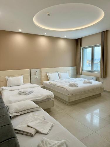 a bedroom with two beds and a circular ceiling at Kristal Garni Hotel in Novi Sad