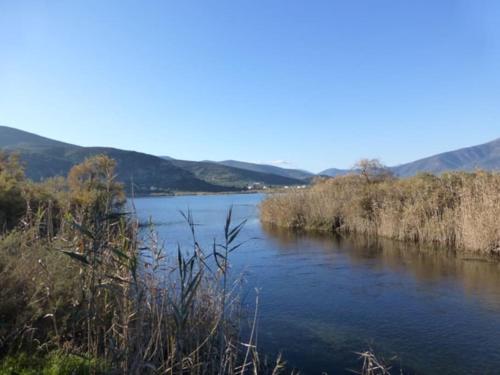 a body of water with mountains in the background at Villa Rastoni in Áyios Andréas Arkadias