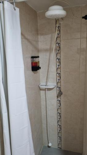 a shower in a bathroom with a shower curtain at Casa Dohko 11 in Bogotá