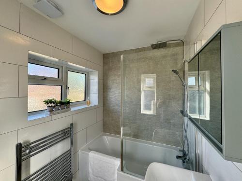 a bathroom with a shower and a bath tub at Sandringham House - Great for Contractors or Family Holidays in Cleethorpes
