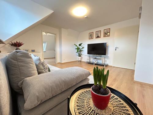 a living room with a couch and a table at JAVU Restaurant & FeWo in Iserlohn