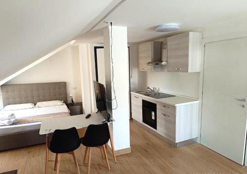 a bedroom with a bed and a table and chairs at Residenza delle Nazioni in Gatteo a Mare