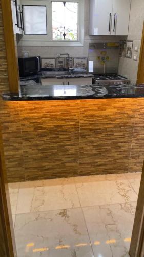 a kitchen with a wooden counter top in a room at Maxeem Direct sea view Apartment super Lux 2 bed rooms Alexandria Maamoura Beach شاليه سوبر لوكس مجموعه مكسيم شاطىء المعموره الاسكندريه على البحرمع كارنيهات بوابه طول السنه و الشاطىء الخاص من اول مايو الى نهايه اكتوبر للعائلات in Alexandria