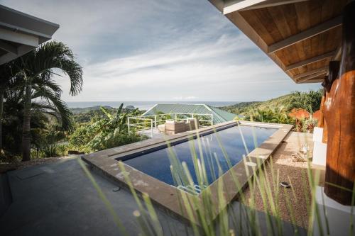 uma vista para uma casa com piscina em Lodge Las Estrellas de Samara em Sámara