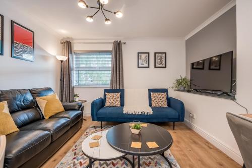 a living room with a couch and a table at Perfect Belfast Stay, 2 Bedroom, Parking, Walkable by StayByNumbers in Belfast