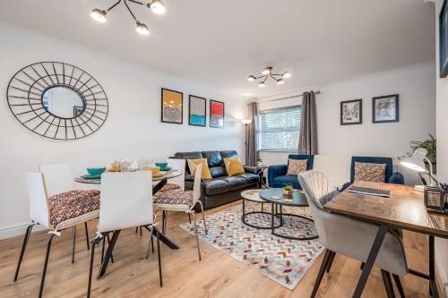 a living room with a couch and a table at Perfect Belfast Stay, 2 Bedroom, Parking, Walkable by StayByNumbers in Belfast