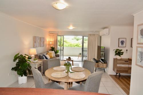 a living room with a table and chairs at City Stadium Apartment 3 in Townsville