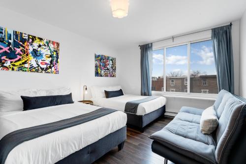 モントリオールにあるLiV MTL Sohoのベッドルーム1室(ベッド2台、ソファ、窓付)