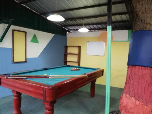 a pool table in a room with a wall at El Remanso in Tonsupa