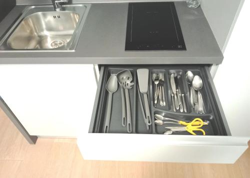a drawer filled with utensils in a kitchen at Residenza delle Nazioni in Gatteo a Mare