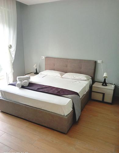 a bedroom with a large bed with white sheets at Residenza delle Nazioni in Gatteo a Mare