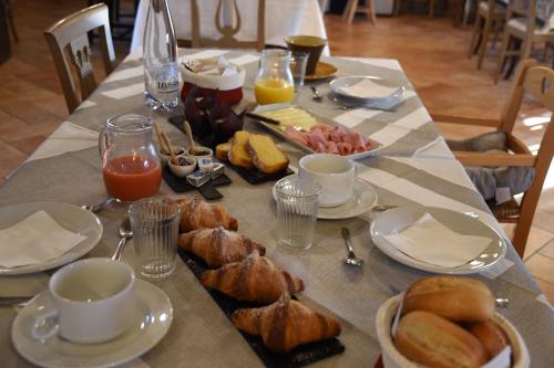 a table with breakfast foods and coffee on it at Agriturismo Poggio ai Legni in Sovicille