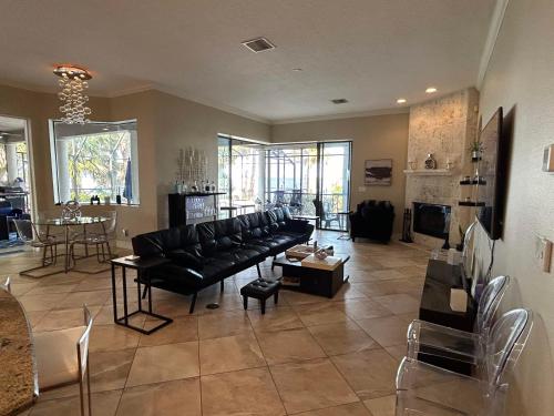 a living room with a black couch and a table at Florida Space Coast Waterfront Retreat in Cocoa
