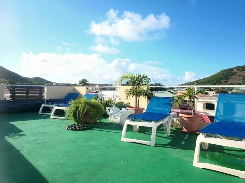 a group of chairs sitting on a roof at Cole Bay Apartments nearby Marinas in Koolbaai