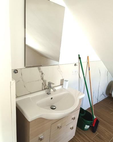 a bathroom with a sink and a mirror at Residenza delle Nazioni in Gatteo a Mare