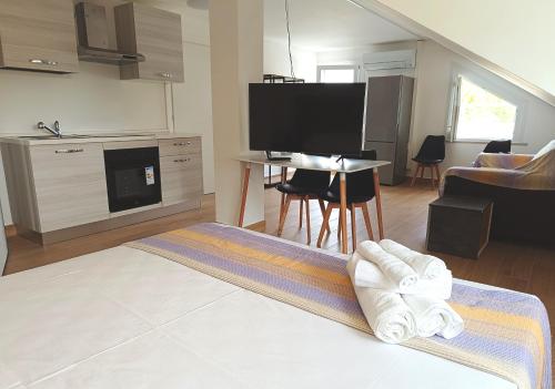 a living room with a couch and a table with towels at Residenza delle Nazioni in Gatteo a Mare