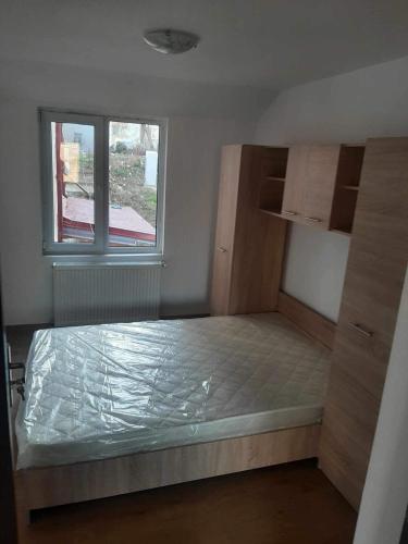a small bedroom with a bed and a window at King srl in Craiova
