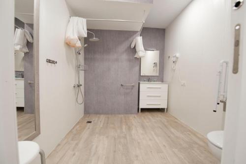 a white bathroom with a sink and a toilet at Pension MD in San Sebastián