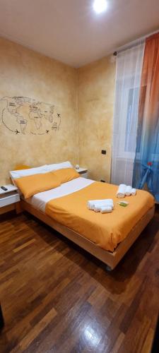 a bedroom with a large bed with towels on it at Wanderlust Pietralata B&B in Rome