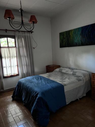 a bedroom with a bed with a blue blanket at La casa de Ana in Alberti