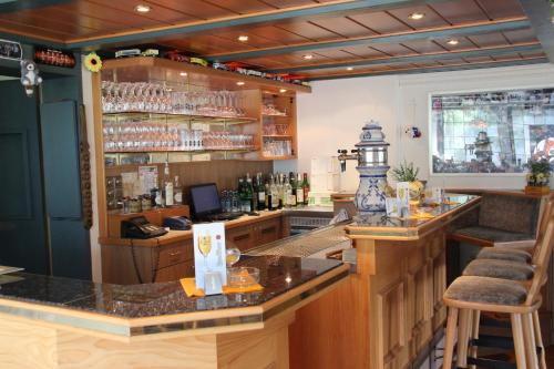a bar with a counter and some bottles of alcohol at Parkhotel Framke in Ehlscheid