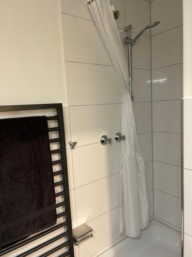 a bathroom with a shower with a shower curtain at TraumAppartment in Mönchengladbach
