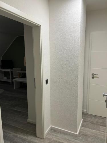 a white door in a room with a hallway at TraumAppartment in Mönchengladbach