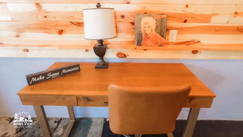 a wooden desk with a lamp and a chair at Modern Luxury-6 Bed 5 Bath CABIN AMAZING LOCATION & PRIVACY! -4 Miles to Gatlinburg-7 to Dollywood-Hot Tub-Fireplace-King Suits-Theater-Grill-Free Parking for 10 Vehicles-Fire pit-Fully Stocked Kitchen-"Smoky View Cabin" in Sevierville
