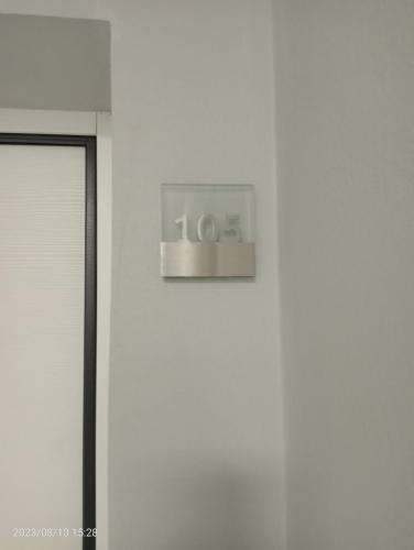 a clock on the side of a white wall at Residenza delle Nazioni in Gatteo a Mare