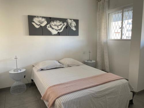 une chambre avec un lit et deux tables et une fenêtre dans l'établissement Le Chantilly, à Cagnes-sur-Mer